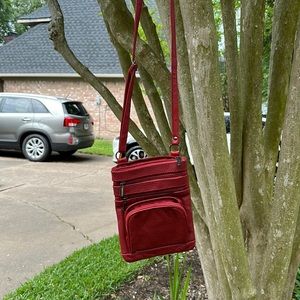 Red Leather crossbody (looks pink in the picture); don’t know who it’s by